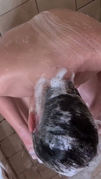 Pissing on a girls face and hair to rinse her off in the shower Clip 1