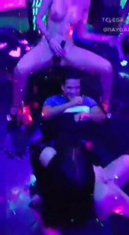 Guy takes a squirt of strippers in a nightclub